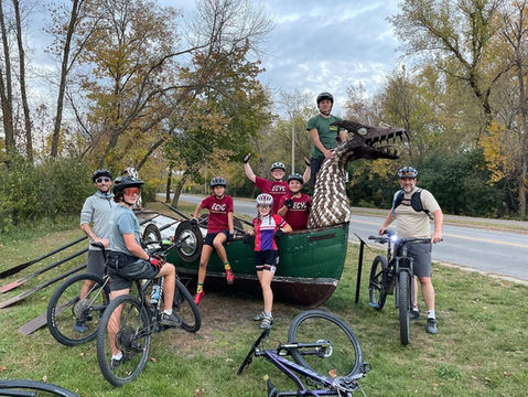 Mountain bikers posing on a sculpture