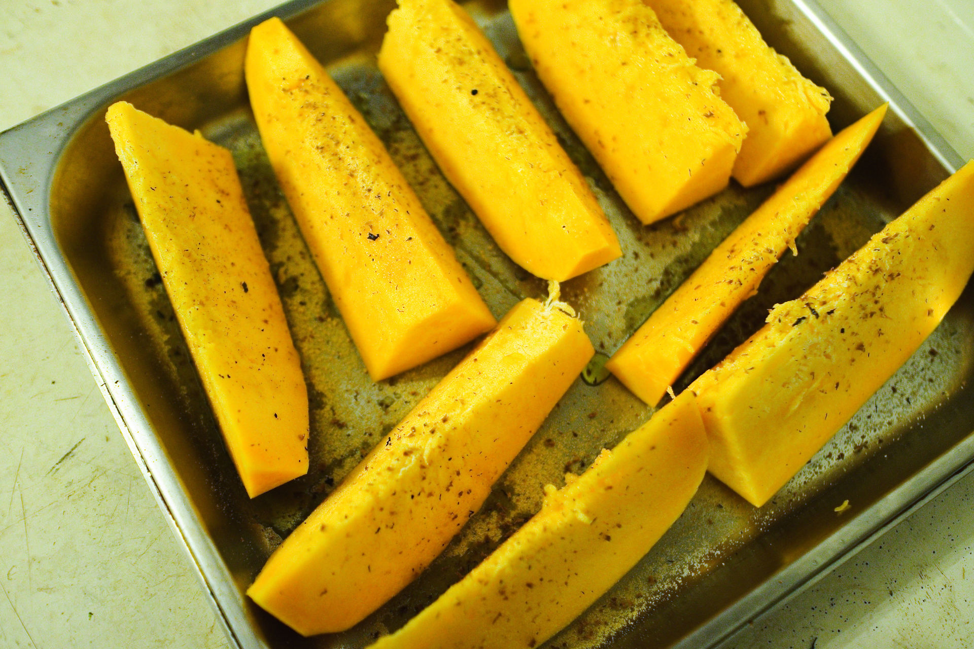 Grating Tonka bean zest over pumpkin steaks to add complex aromas of vanilla and almond.