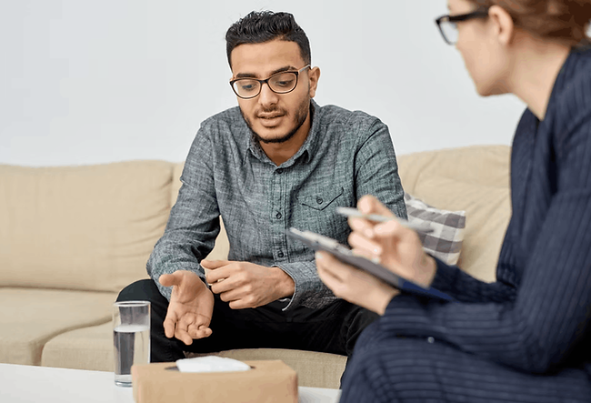 A man speaks to a therapist during a session of trauma therapy in Brooklyn, NY