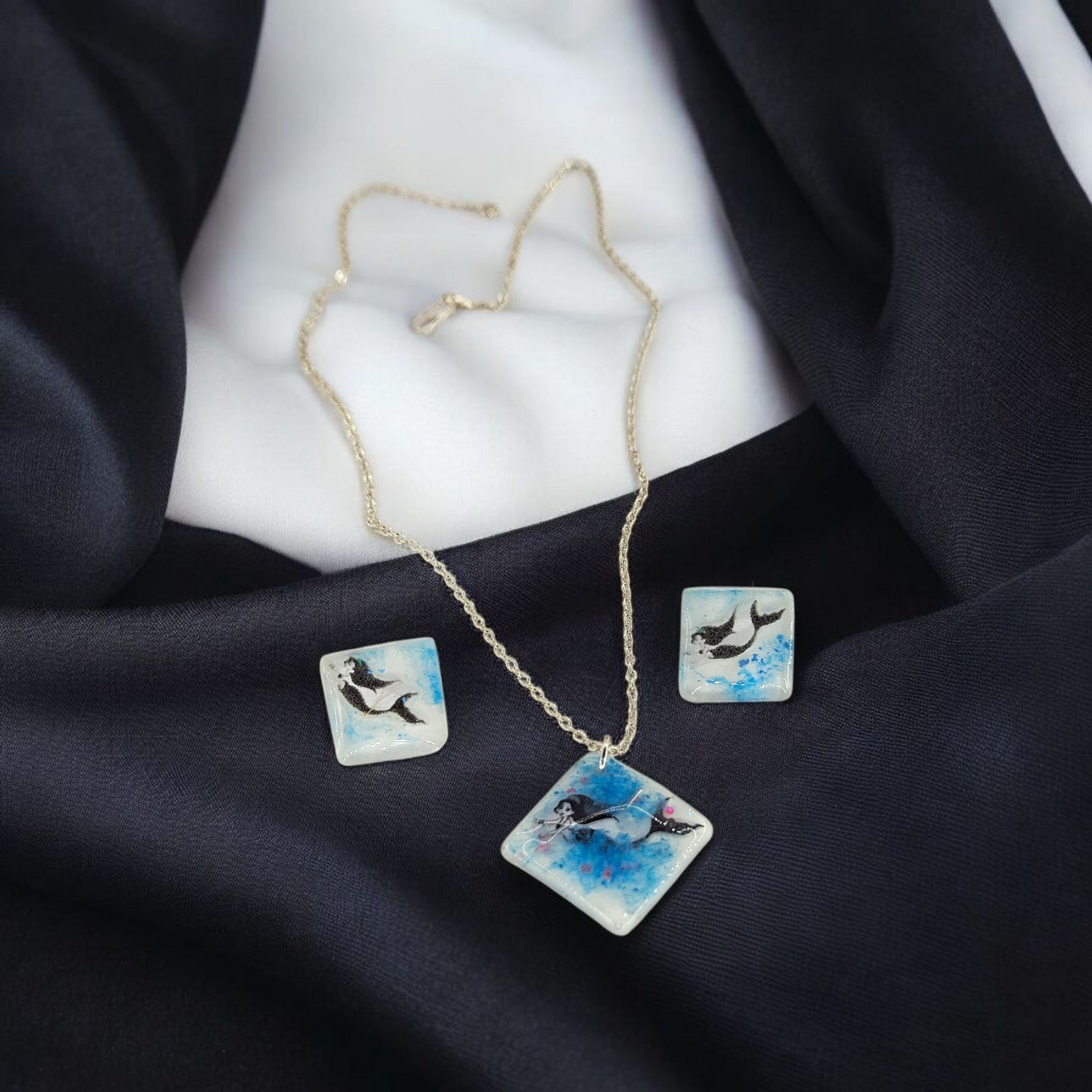 Front view of Mermaid Whispers women’s mermaid necklace and earrings set with ocean-inspired design