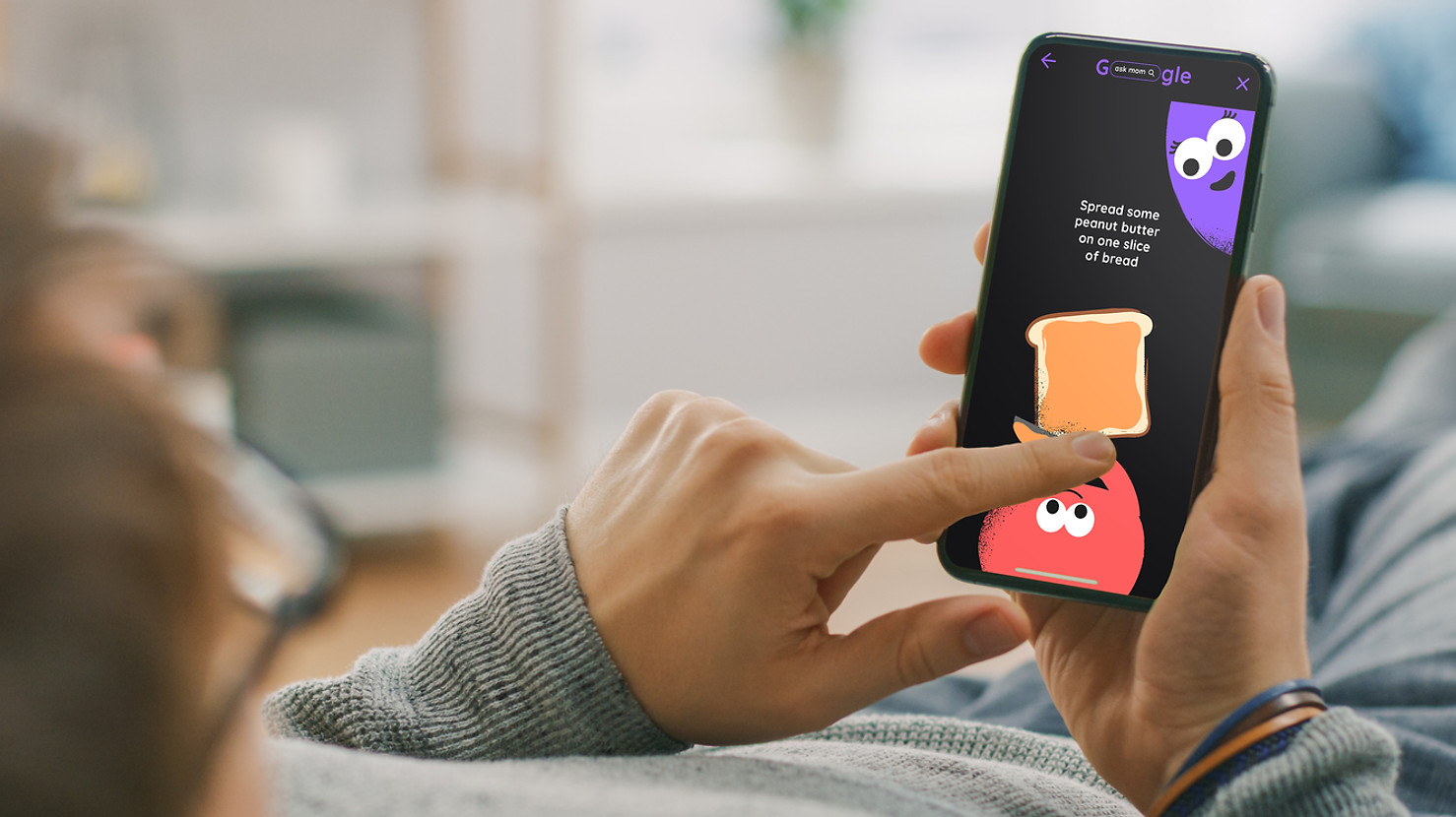 Person swiping in Google doodle experience to make a sandwich