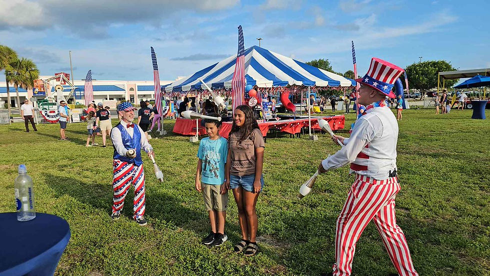 Families and guests enjoying entertainment and activities at an outdoor community festival.