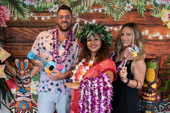 guests posing with hula dancers