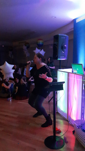 Child singing karaoke at an event