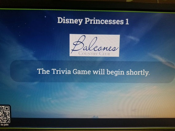 Screen showing “Disney Princesses 1” with a sponsor logo and the text “The Trivia Game will begin shortly” against a blue gradient background.