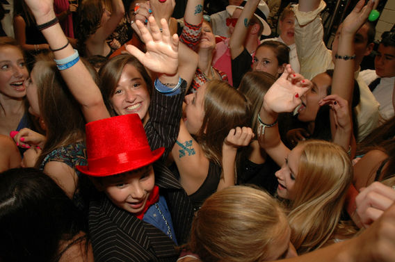 Guests dancing with party props at a mitzvah event