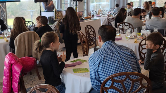 Families playing Bingo during a client-hosted event presented by Magical Memories Entertainment