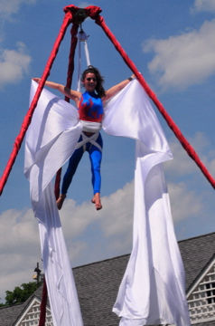 A vibrant circus show featuring acrobats, clowns, and other performers entertaining guests at a country club event