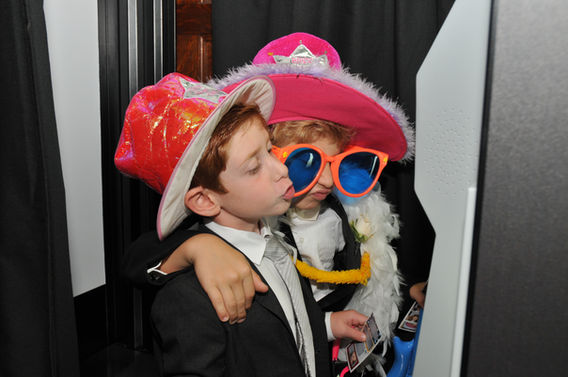 Kids wearing costumes inside arcade photo booth