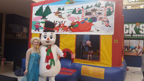 A Disney princess and a snowman costumed character standing together, showcasing their colorful costumes at a festive event