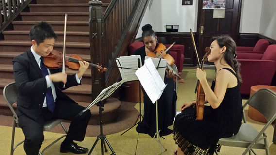 String trio performing classical music indoors