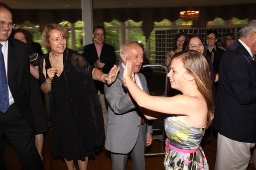 Guests celebrating and high-fiving during a Bar Mitzvah party.