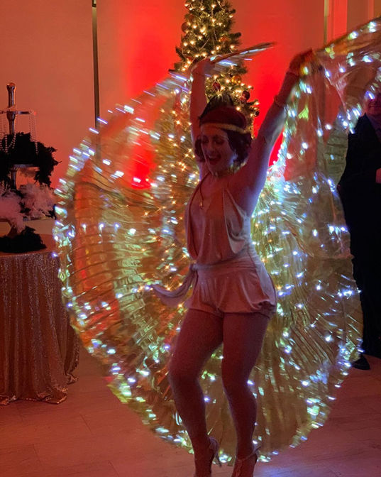 A LED entertainer showcasing glowing lights and dynamic movements at a charity gala