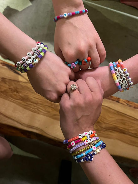 Friends wearing bracelets from jewelry bar