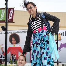 Stilt walker in a colorful costume at an event.