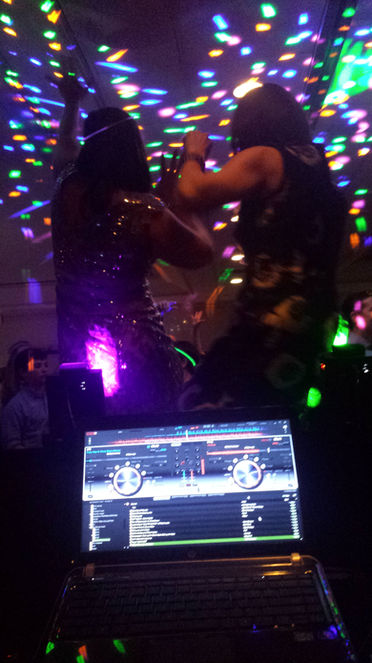 The dance floor is alive with energy as the DJ ignites the party with pulsating beats and irresistible rhythms. Surrounded by colorful lights and enthusiastic dancers, the DJ commands the crowd with seamless mixes and crowd-pleasing tracks. Guests move to the music with abandon, their spirits lifted by the infectious energy of the dance party. It's a scene of pure joy and celebration, where music brings people together to dance the night away and create unforgettable memories.