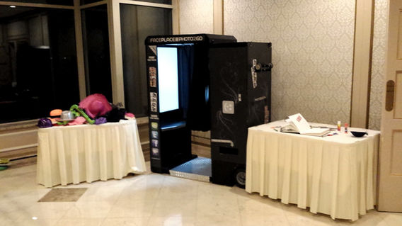 Arcade photo booth setup with props table