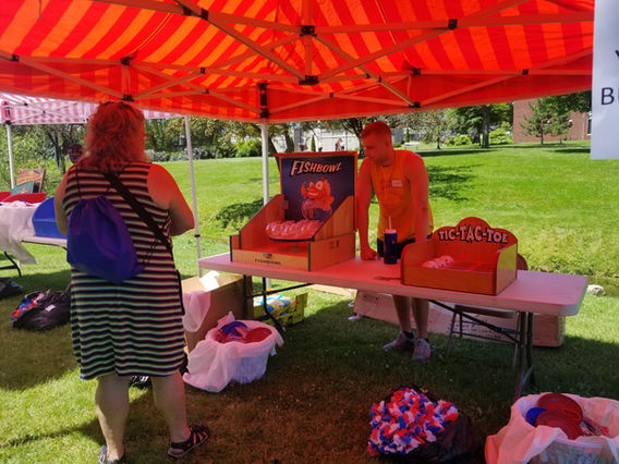Carnival booth with Fish Bowl and Tic Tac Toe games set up outdoors by Magical Memories Entertainment.