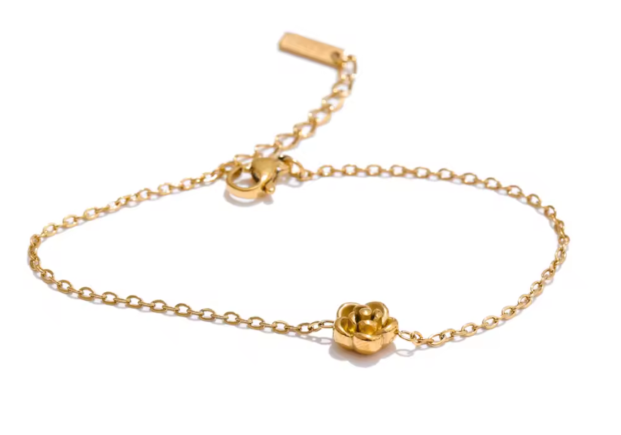 Gold stainless steel bracelet with a rose flower charm from Orizo displayed on a white background.