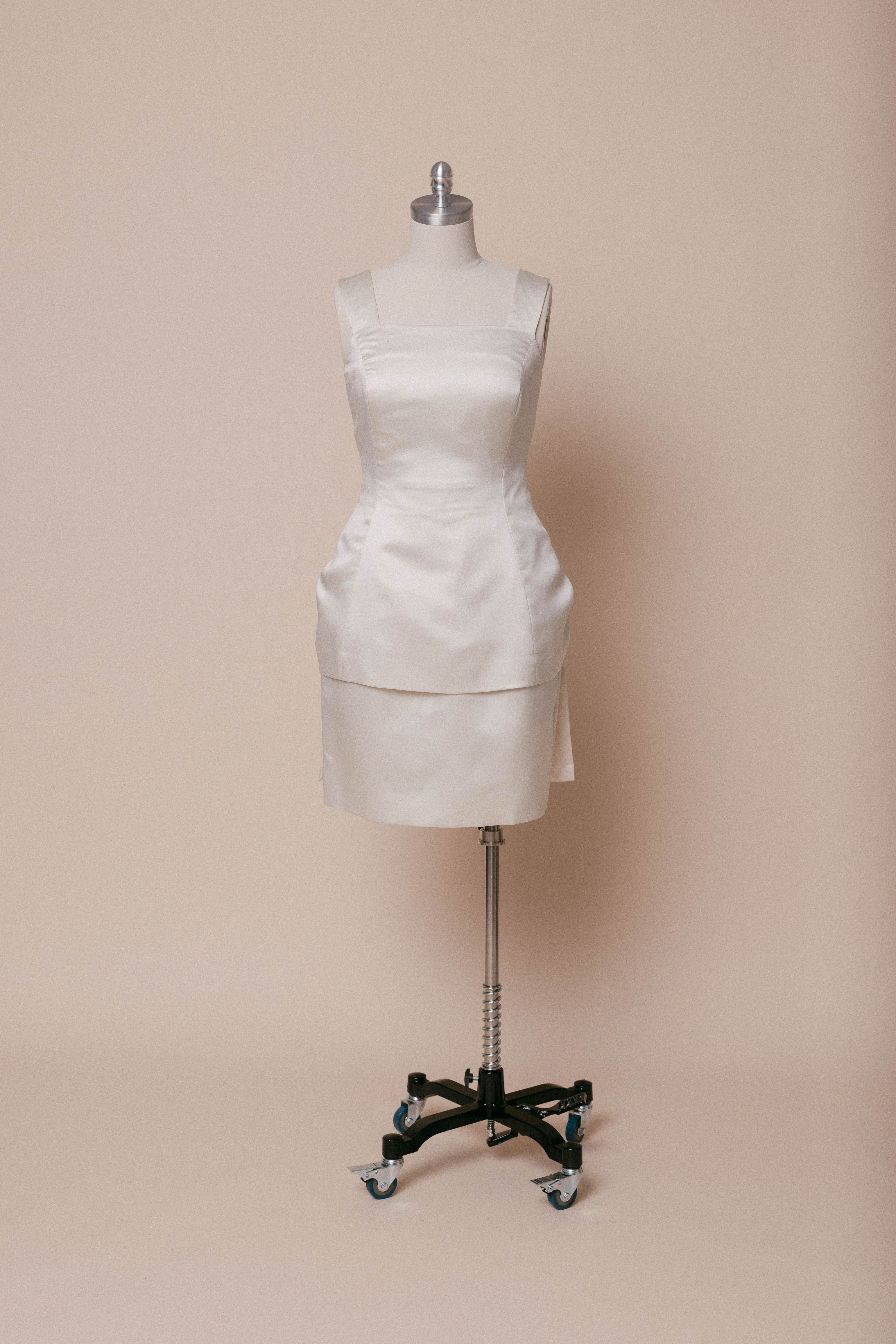 Plus size 1992 Vera Wang mini dress on dress form against ivory backdrop