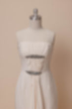 Vintage Carolina Herrera wedding dress on a dress form against an ivory backdrop