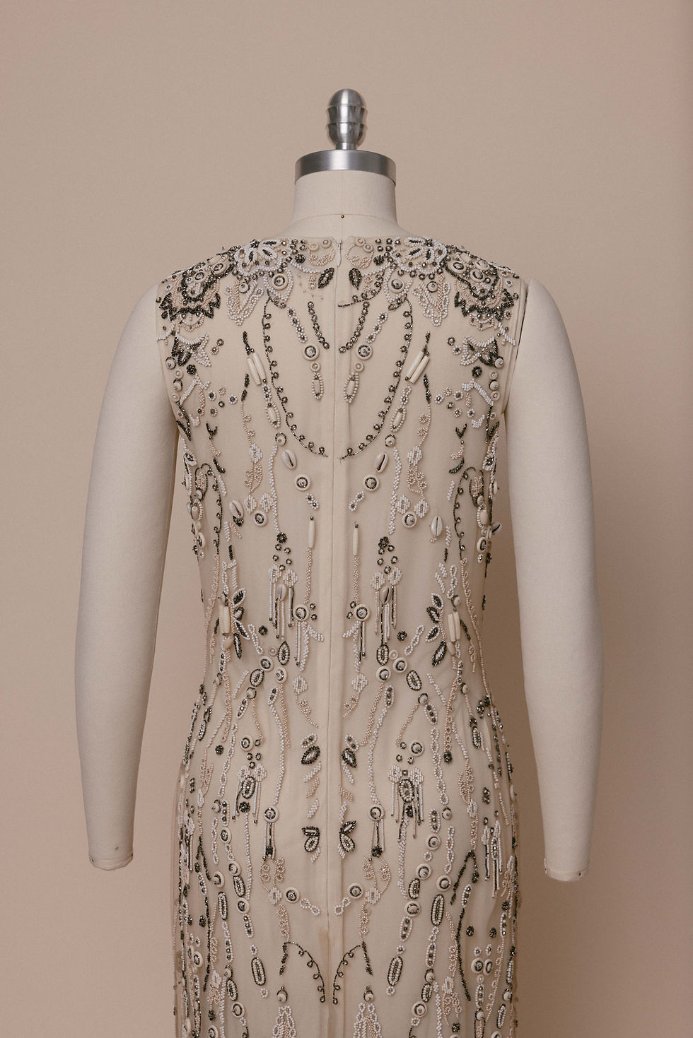 Thumbnail: Fall 2015 Ralph Lauren Collection heavily beaded dress on a dress form against an ivory backdrop