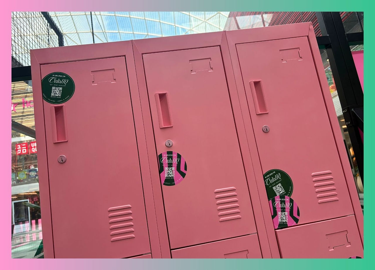 Pink lockers with Club HQ QR code booking stickers advertising padel, pilates and yoga, 1st to 31st August.
