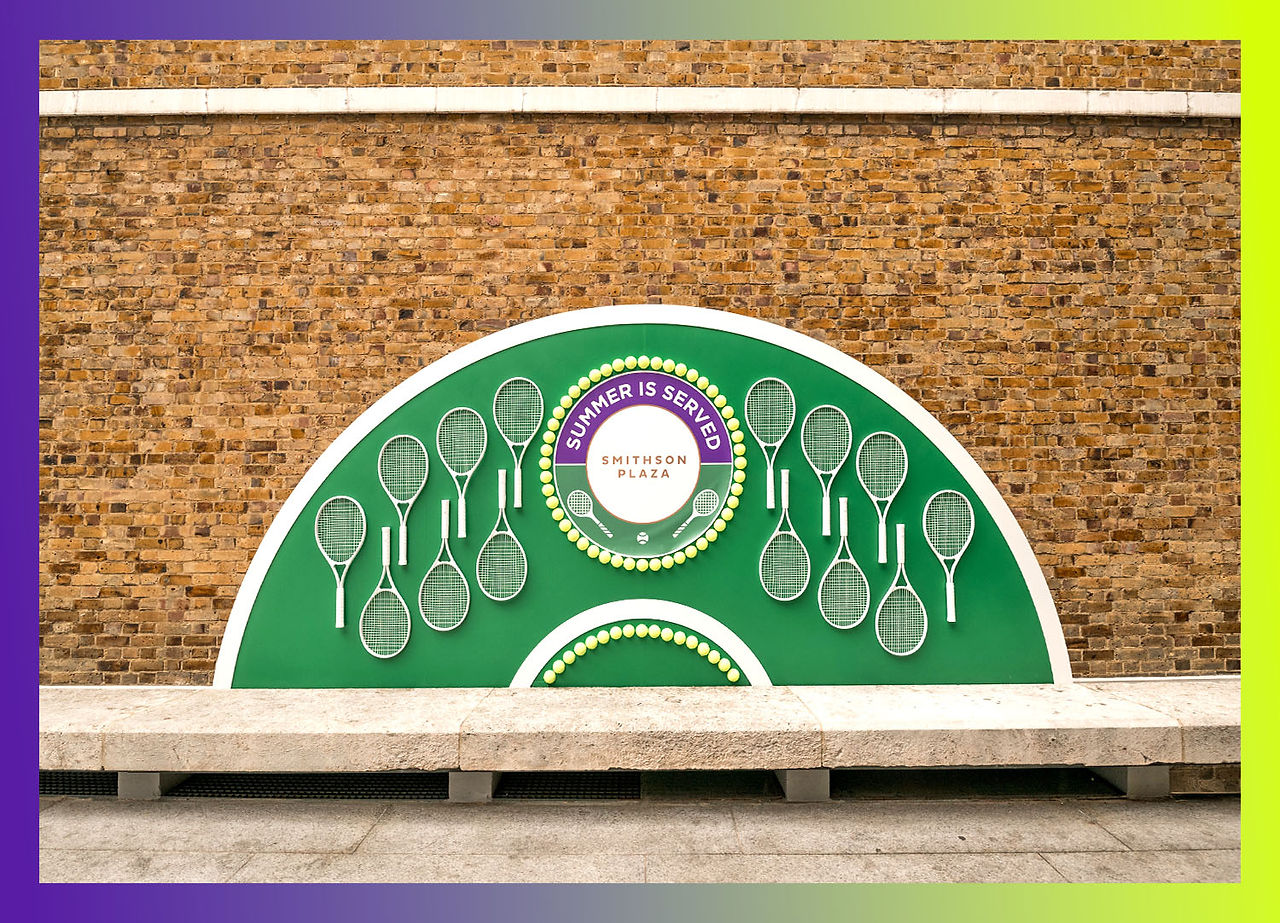 A selfie wall at Smithson Plaza, decorated with tennis rackets and balls, exuding the summer vibe and capturing the spirit of Wimbledon. The vibrant display offers the perfect backdrop for attendees to snap memorable photos and share their Wimbledon experience with friends and followers.
