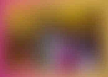 Two women taking a selfie in front of a massive Christmas tree at Coal Drops Yard. The tree and surrounding buildings are adorned with festive lights, adding warmth to the evening.