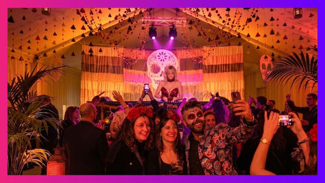 Daylesford Organic Day of the Dead Fiesta illuminated sugar-skull backdrop with crowd