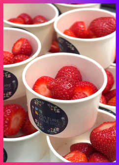 Branded Culture Mile BID paper cups filled with fresh strawberries.