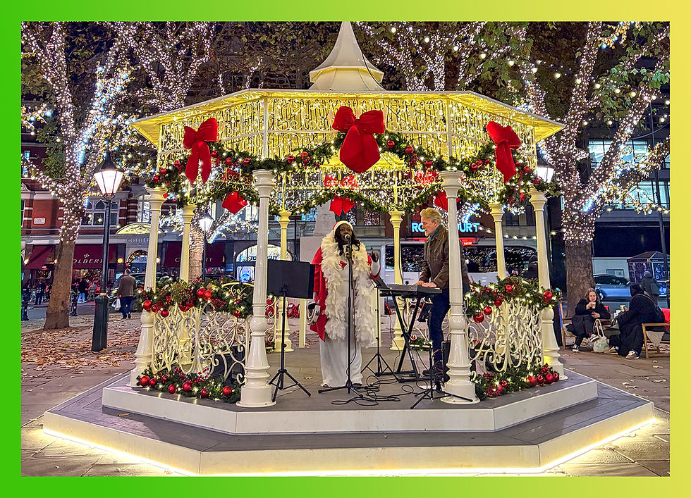 A beautifully illuminated winter pavilion at Sloane Square, decorated with garlands, red ribbons, and twinkling lights.