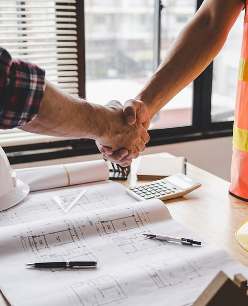 Professional handshake between a homeowner and a contractor on site.