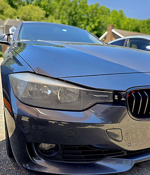 Cloudy BMW headlight before professional restoration.