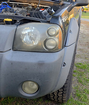 Foggy SUV headlights before professional restoration.