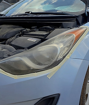 Cloudy headlight before professional headlight restoration.