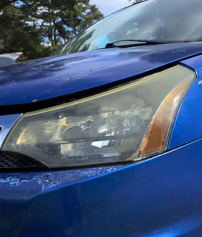 Oxidized blue car headlight before restoration service.