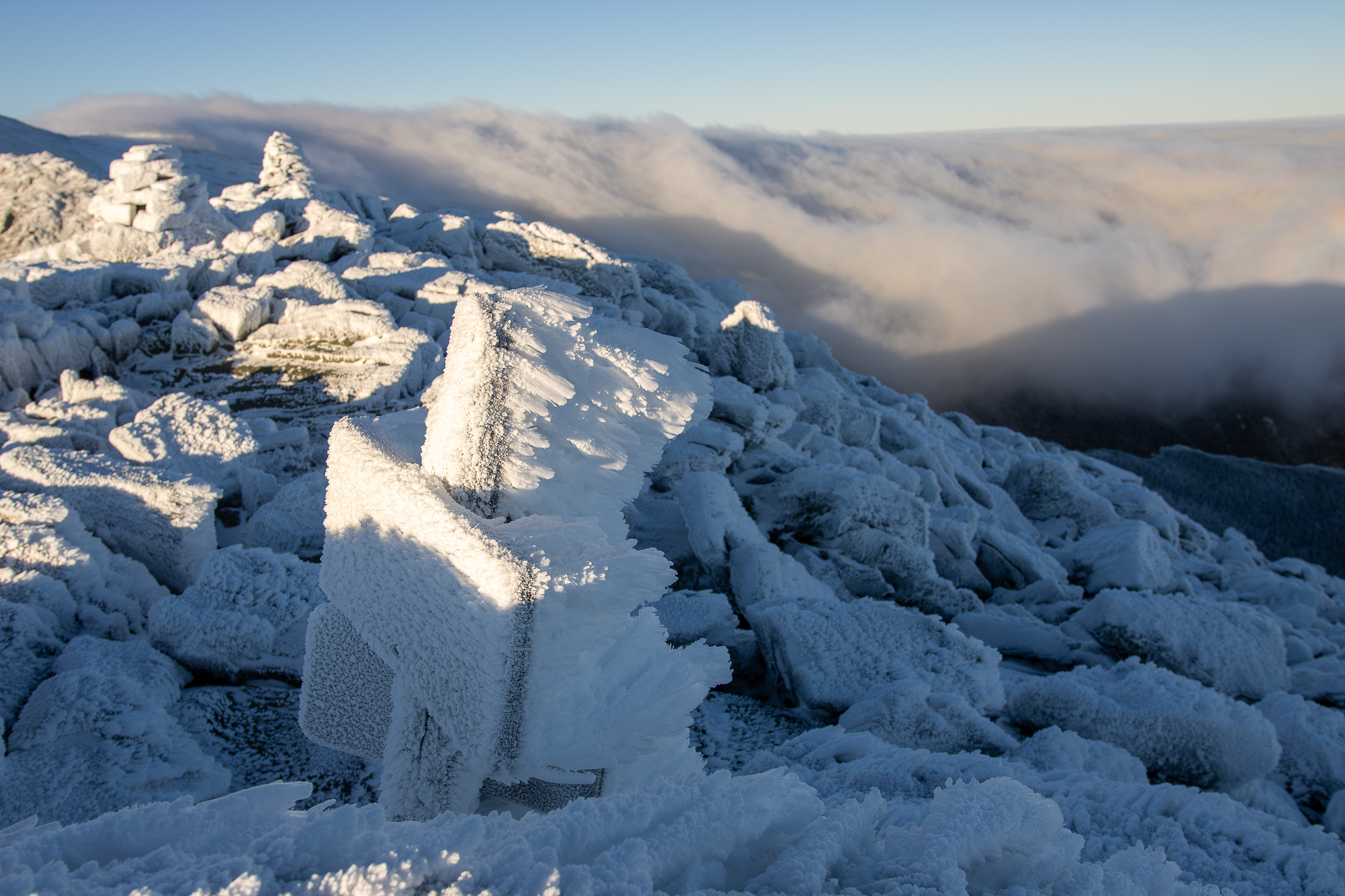 Mt. Madison in Winter Summit & Sign with undercast cloud cover and Brocken Sprectre