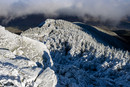 Snow‑covered Durand Ridge and evergreen trees blanketed in rime ice, with dark clouds above a shadowed valley.