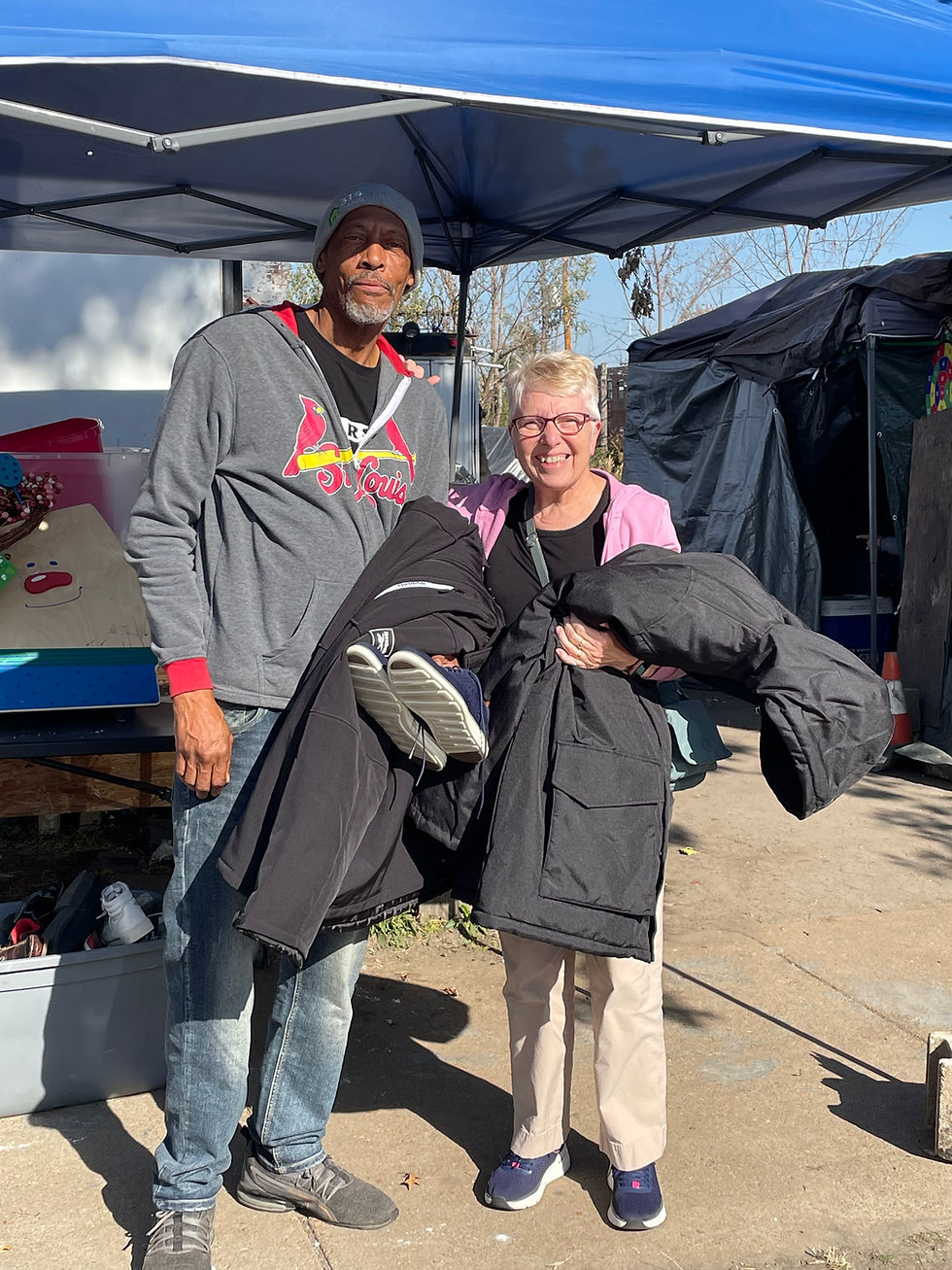Larry standing with his jacket in his hamds.