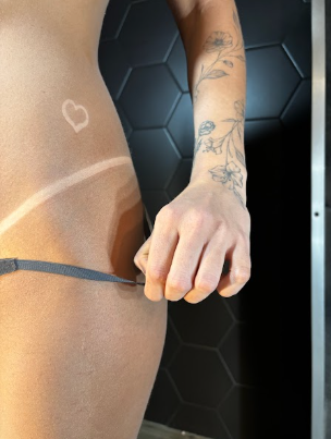 An image of a woman showing her spray tan