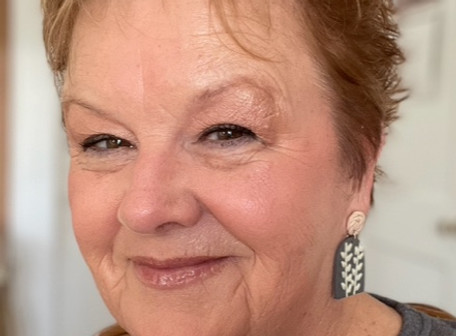 White woman with short brown hair smiling