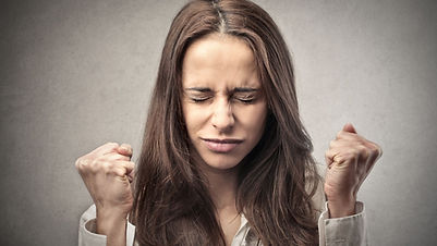 Woman clenching fists, stressed expression