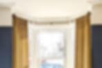 Victorian bay window with velvet curtains