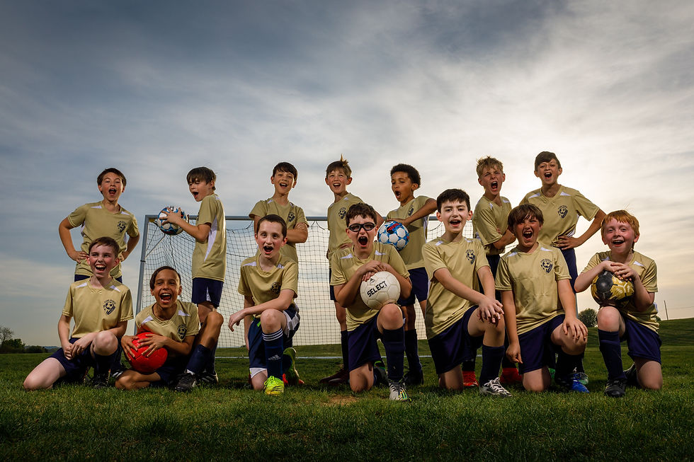 A youth soccer team shouts into a camera at sunset.