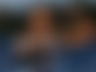 cheerleader flexing her muscles while holding a football