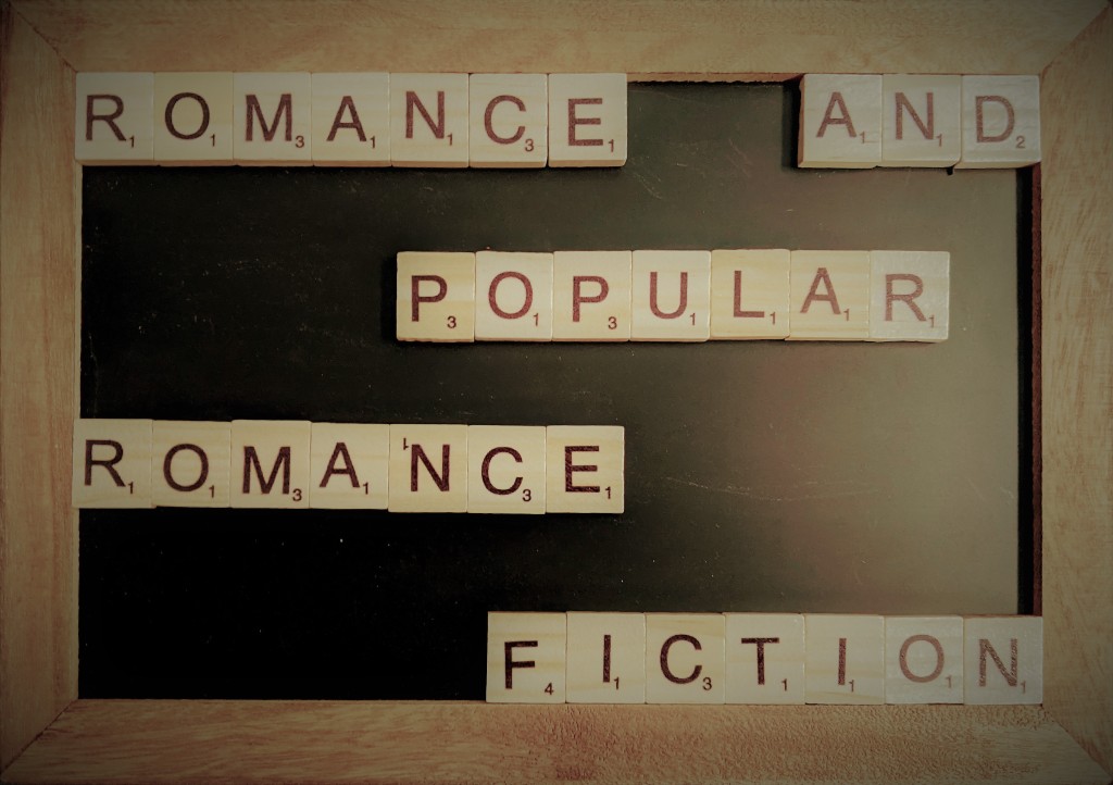 A chalk board with scrabble tiles that spell out "Romance and Popular Romance Fiction".