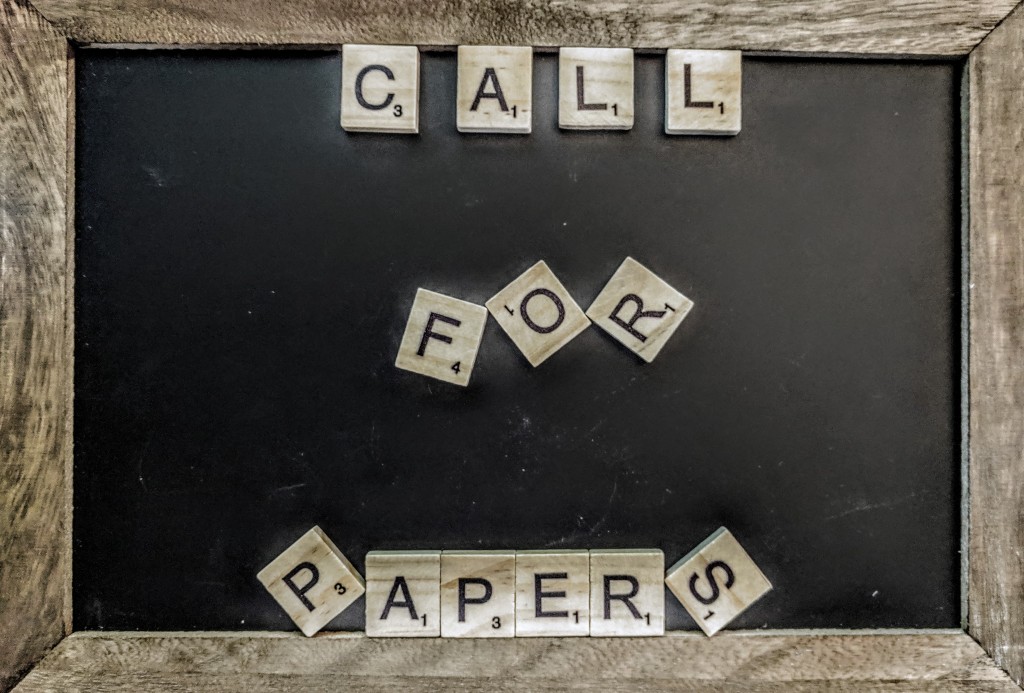 A chalk board with Scrabble tiles that spell out "Call for Papers"
