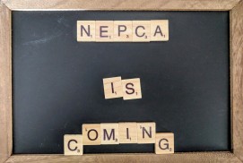A chalk board with Scrabble letters spelling out "NEPCA is coming" in the center.