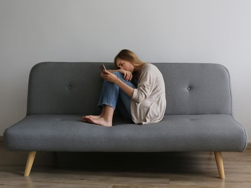 Woman with burnout symptoms and exhaustion reaching to a somatic coach to get support for burnout recovery